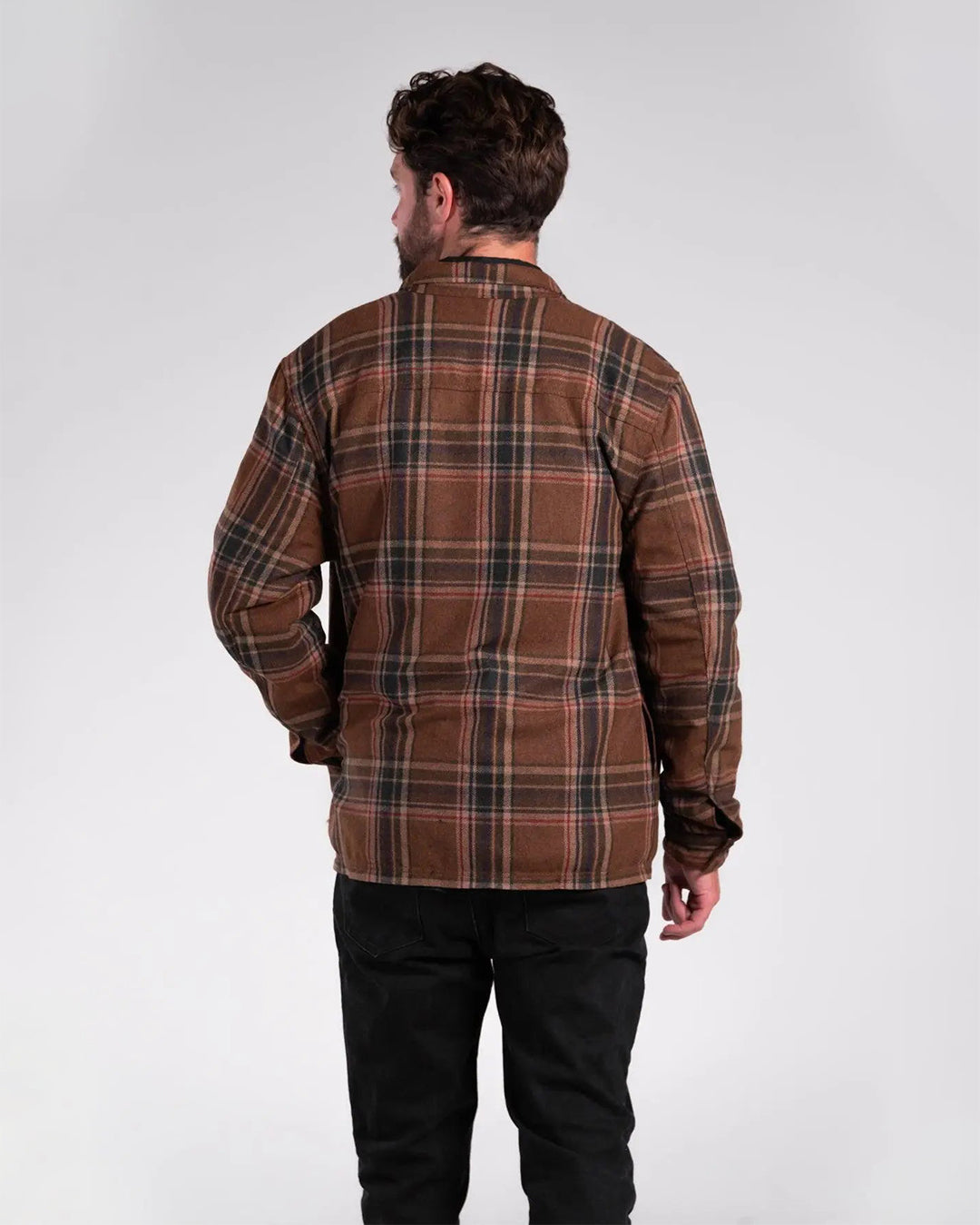 Rear view of man wearing plaid wool motorcycle shacket showing the pure wool outer layer and DuPont™ Kevlar® lining for abrasion resistance