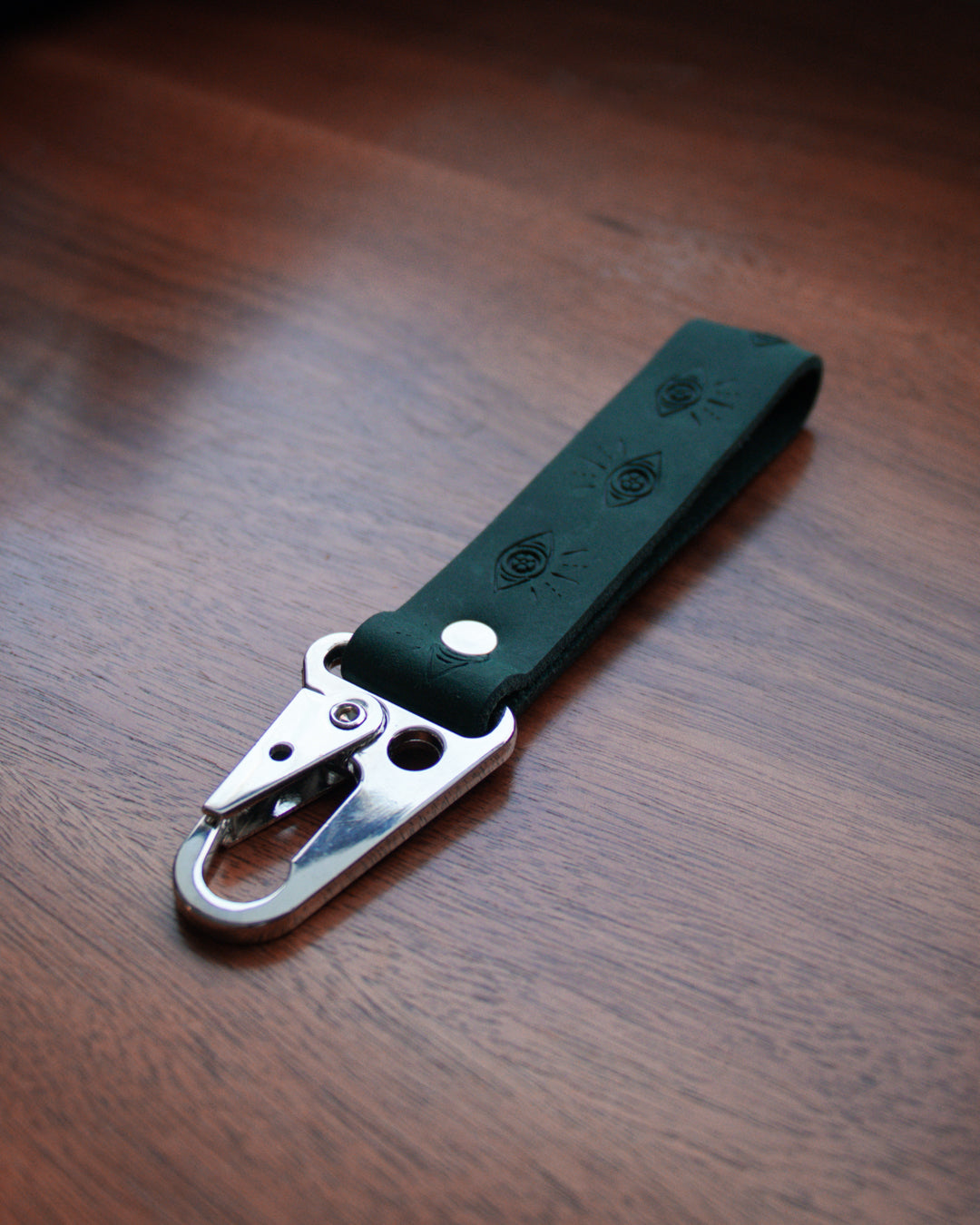 Top view of simple, black leather keychain