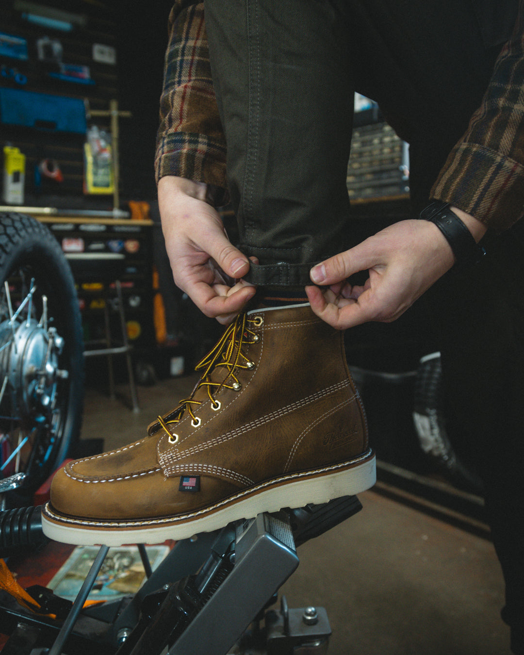 Man wearing brown, American-made, full-grain leather moc-toe workboots with steel toe and non slip sole