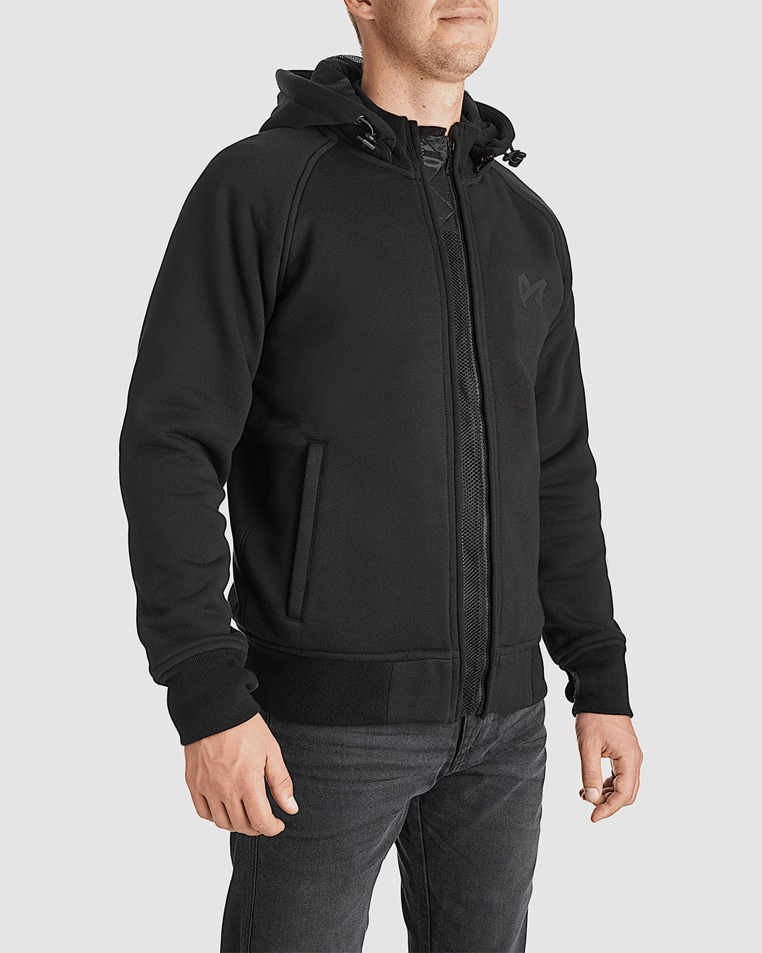 Man wearing black CE AA-approved zip-up hoodie made from abrasion-resistant UHMWPE with ventilation zips and joint armor